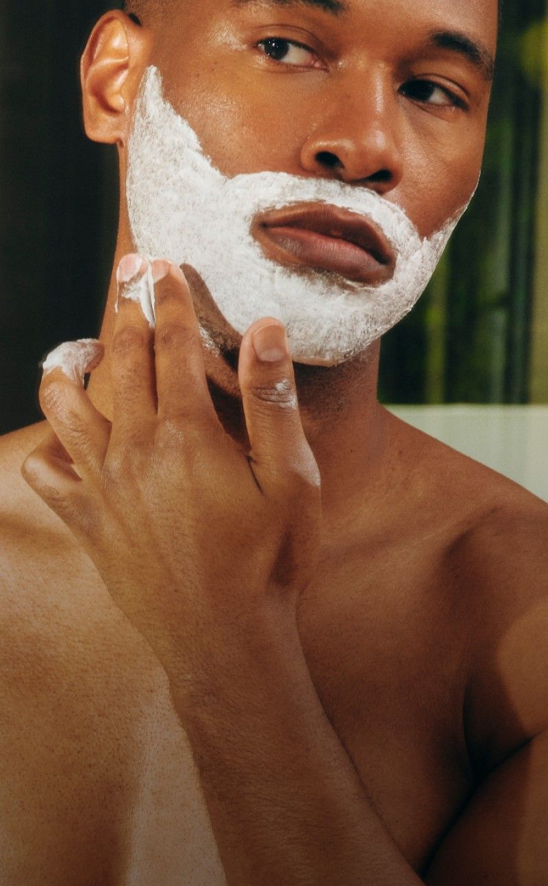 Man applying shaving cream to his face